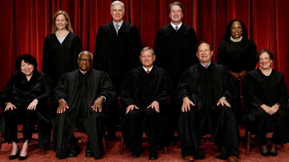 Seated (L-R): Justices Sonia Sotomayor, Clarence Thomas, Chief Justice John Roberts, Samuel Alito, and Elena Kagan
Standing (L-R): Justices Amy Coney Barrett, Neil Gorsuch, Brett Kavanaugh and Ketanji Brown Jackson